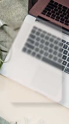 an open laptop computer sitting on top of a table next to a cup of coffee