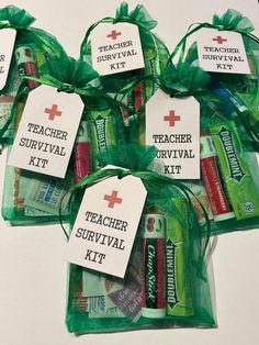 teacher survival kit wrapped in green organ bags with red cross tags on each bag and the words teacher survival written on them