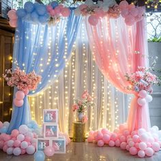 a decorated stage with balloons, flowers and decorations for a baby's first birthday