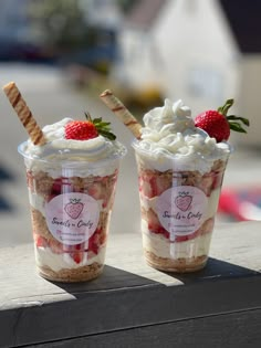 two dessert cups with strawberries and whipped cream