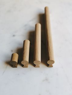 three wooden dowks sitting on top of a white counter