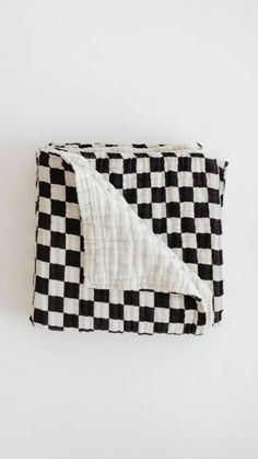 the black and white checkered blanket is folded up