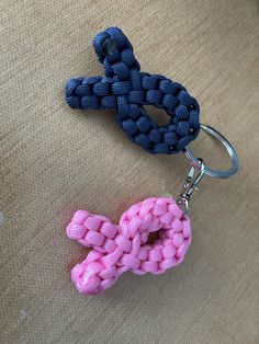 two keychains that have been made to look like the letter c and q