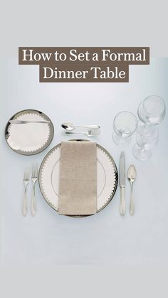 a place setting with silverware and napkins on a white tableclothed surface