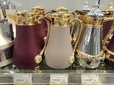 many different types of vases on display in a store