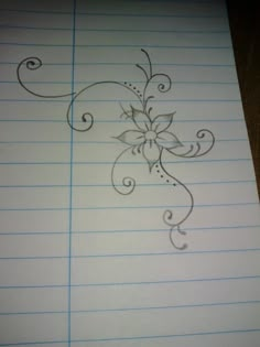 a piece of lined paper with a drawing of a flower on the top and bottom