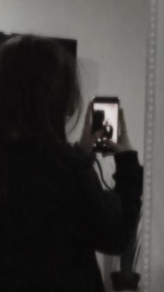 a woman is taking a selfie in front of a mirror with her cell phone