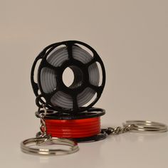 a spool of red and black wire on a chain