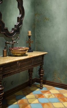 a sink and mirror in a room with green walls, checkered tile flooring