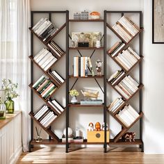 a bookshelf filled with lots of books on top of a hard wood floor