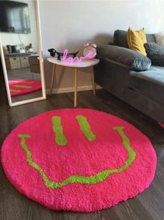 a living room with a couch, mirror and smiley face rug