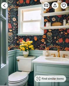 a bathroom with floral wallpaper and blue walls