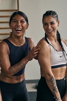 two women standing next to each other smiling