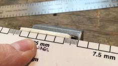 a close up of a person holding a tape measure