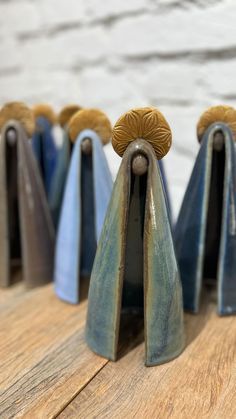 several blue and gold ceramic sculptures on wooden boards