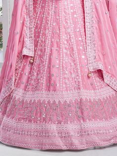 Elevate your style with the timeless elegance of this enchanting pink chiffon lehenga, adorned with intricate multi-embroidered work and shimmering sequins. The soft and flowing chiffon fabric drapes gracefully, exuding a delicate charm that is perfect for a variety of occasions, from weddings to receptions and beyond. Semi-stitched for convenience and comfort, the lehenga accommodates up to 42 inches, ensuring a flattering fit for different body types.
Paired with the lehenga is a chiffon choli Pink Chikankari Embroidery Salwar Kameez In Chinon, Pink Lehenga With Sheer Dupatta For Navratri, Pink Organza Choli For Navratri, Pink Semi-stitched Salwar Kameez For Reception, Pink Wedding Salwar Kameez With Intricate Embroidery, Festive Pink Chikankari Anarkali Set, Pink Organza Lehenga For Navratri, Pink Anarkali Gown With Intricate Embroidery, Pink Embroidered Chinon Anarkali Set