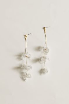 Adina Strand Earrings by A.B. ELLIE Bridal Accessories — A.B. ELLIE Delicate Chandelier Earrings For Party, White Flower Earrings For Celebration, Delicate Dangle Bridal Earrings For Evening, Delicate Bridal Earrings For Party, Clear Dangle Earrings For Wedding, Delicate Flower Bridal Earrings For Party, Elegant Clear Flower Shaped Earrings, Wedding Jewelry With Matching Clear Earrings, Delicate White Chandelier Earrings For Formal Occasions