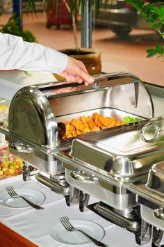 a buffet is set up with food and silverware