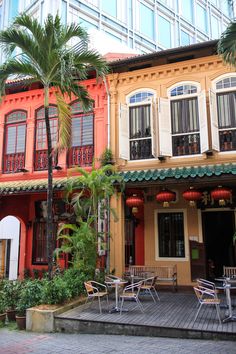 two buildings with palm trees in front of them