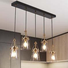 four lights hanging from the ceiling in a kitchen