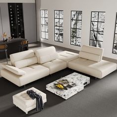 a modern living room with white furniture and large windows