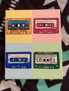 four different colored cassette tapes painted on canvases