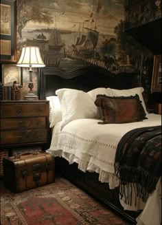 a large bed sitting next to a lamp on top of a wooden dresser in a bedroom