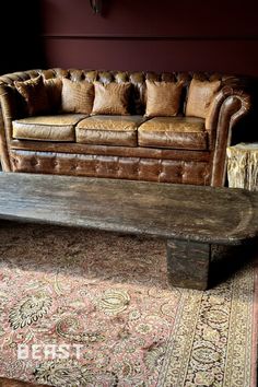 a living room with a couch, rug and table in front of the couches