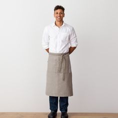 "We're excited to offer our own classic bistro waist apron. And make no mistake, this is no run-of-the-mill apron. The soft, durable, 100% cotton fabric is produced on a 100 year-old handloom in my partner's hometown of Kannur, India. To achieve a natural feel, no starch is added to the yarn at the weaving stage. The classic bib style apron is as practical as it is good looking. Includes two large pockets below the waist. Features a blue ticking stripe embellishment. Waist strap is long enough t Waiter Restaurant, Waiter Outfit, Classic Restaurant, Apron For Women, Restaurant Ideas