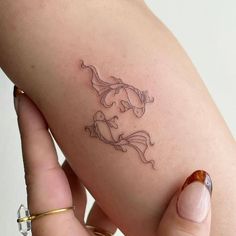 a woman's arm with a small tattoo on the left side of her body