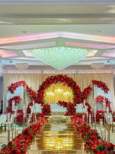 an aisle decorated with red flowers and greenery for a wedding ceremony at the grand hyate