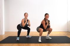 two women doing squats on exercise mats