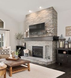 a living room filled with furniture and a flat screen tv mounted on the wall above a fireplace