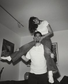 a man carrying a woman on his shoulders