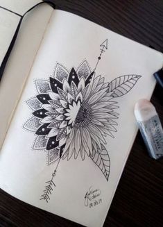 an open book with a drawing of a flower on it