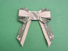 dollar bill origami bow on green background