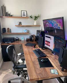 a computer desk topped with two monitors and a keyboard