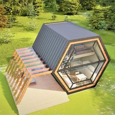 an aerial view of a small house in the middle of a field with stairs leading up to it