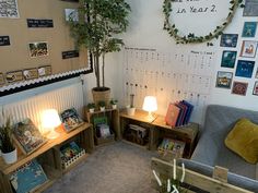 a living room filled with lots of furniture next to a wall covered in pictures and plants