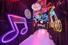 a hallway with neon lights and musical notes