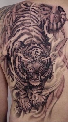 a man with a tiger tattoo on his back