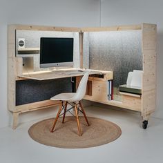 a desk with a computer on it and a chair next to it in front of the monitor