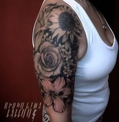 a woman wearing a white tank top with sunflowers and roses on her arm