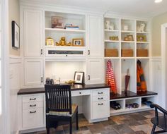 a room that has some white cabinets and black chairs in it with brown tile flooring