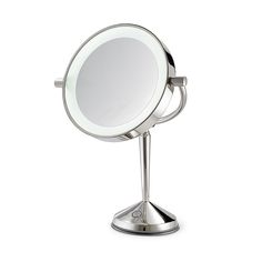 a small round mirror on a stand with a light in the middle and one arm extended