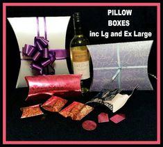 a bottle of wine and some candy next to a gift bag with the words pillow boxes inc lg and ex large