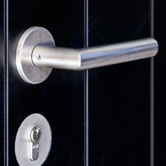 a close up of a door handle on a black door