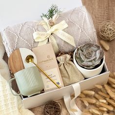 an open box with some items in it on a table next to yarn and other things