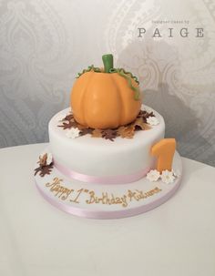 a birthday cake with a pumpkin on top