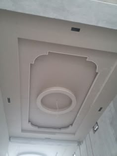 the ceiling is white and has a circular light fixture